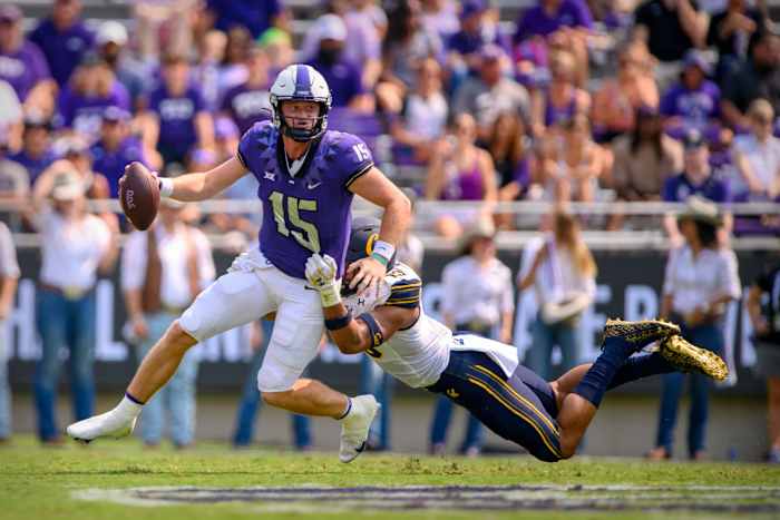 Cameron Goode (19) stretches out to tackle TCU quarterback Max Duggan (15).